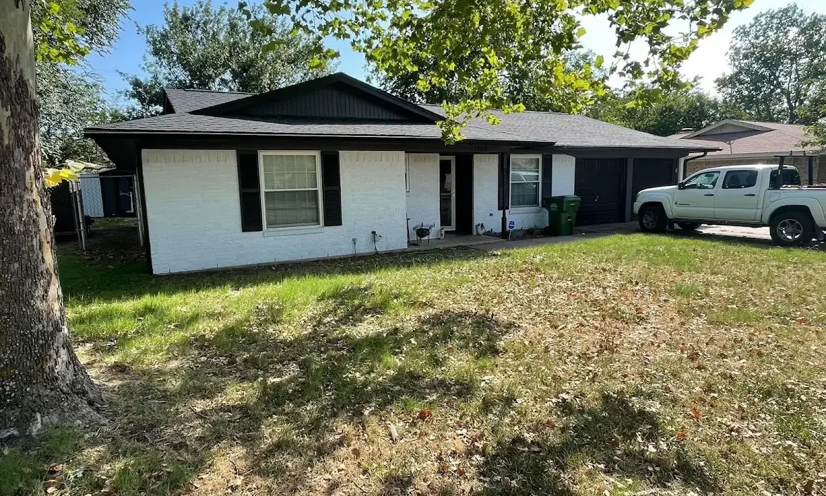 Professional roofing crew working on a residential roof in Country Club Hills